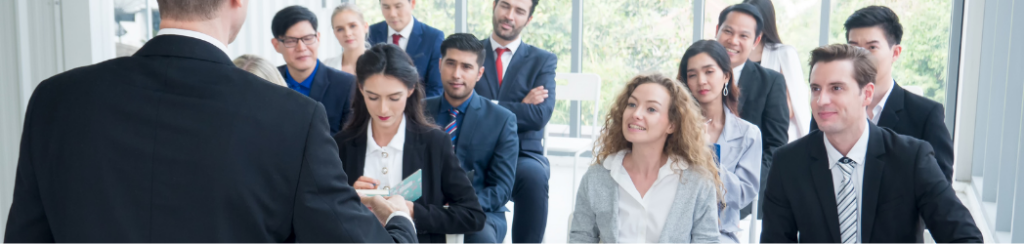 A group of employees listening to a seminar on ways to promote workplace wellness